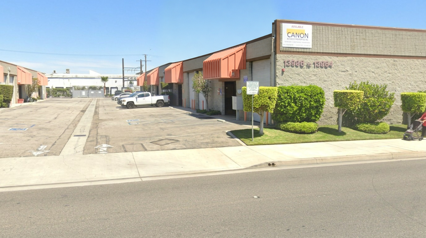 Wide exterior view of the real 310 Tintz shop and its peach awnings